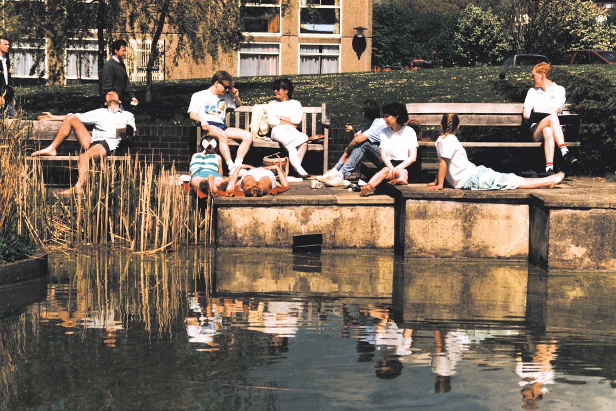 Students relaxing on the campus lake, 1980